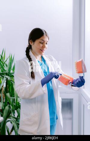 Jeune femme orthodontiste en robe médicale et gants jetables avec mâchoire moulée à l'hôpital Banque D'Images