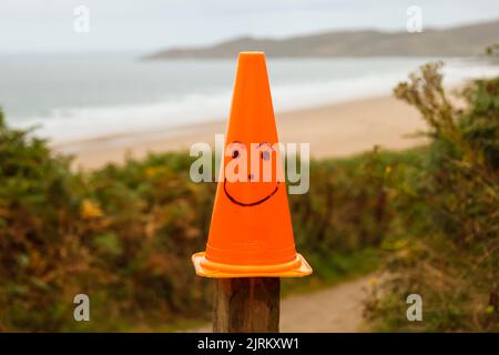 Happy face à la pointe de la route orange sur la plage de la baie de Woolacombe, North Devon, Angleterre, Royaume-Uni Banque D'Images