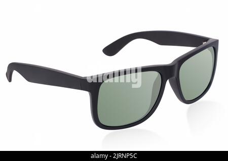 Lunettes de soleil noires mates à monture en plastique avec verres polarisés verts sur fond blanc avec reflet de l'ombre Banque D'Images