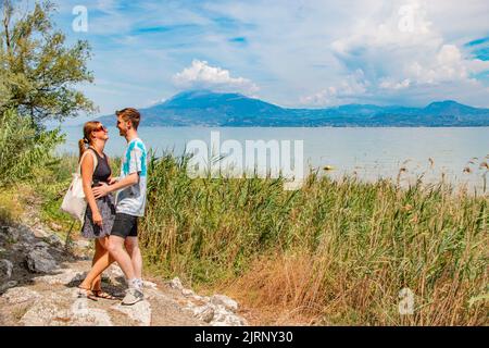 Joyeux jeune couple touristique en lune de miel dans la romantique Sirmione, sur le lac de Garde, Brescia, Italie Banque D'Images