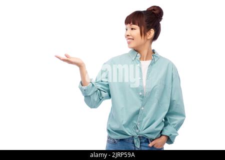Happy asian woman holding quelque chose en main Banque D'Images