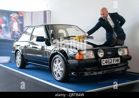 Arwel Richards, spécialiste automobile classique de Silverstone Auctions, polit l'Escort RS Turbo 1985 de Ford, qui appartenait auparavant à Diana, princesse de Galles, sur le circuit de course de Silverstone près de Towcester, dans le Northamptonshire, avant qu'il ne passe sous le marteau samedi aux Silverstone Classics. Date de la photo: Vendredi 26 août 2022. Banque D'Images