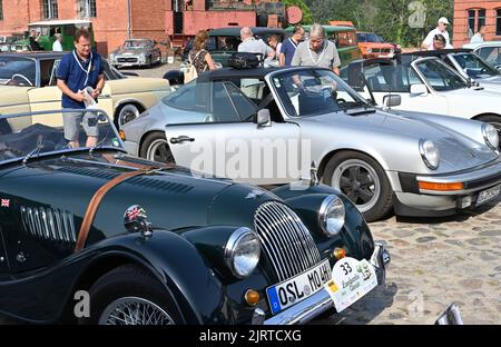 Nauen, Allemagne. 26th août 2022. Un Morgan 4/4 plus (construit en 1964) se trouve à côté d'une Porsche 911 Targa avant le début de l'ADAC Landpartie Classic au domaine Stober. Environ 100 voitures classiques de 33 fabricants se mettent en route pour la promenade en voiture classique dans la région de Havelland. Credit: Bernd Settnik/dpa/Alay Live News Banque D'Images