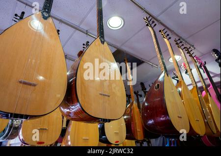 Istanbul, Turquie 2022. Des rangées d'instruments à cordes ethniques turcs saz et baglama dans un magasin en vente au Grand Bazar Banque D'Images