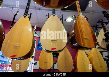 Istanbul, Turquie 2022. Des rangées d'instruments à cordes ethniques turcs saz et baglama dans un magasin en vente au Grand Bazar Banque D'Images