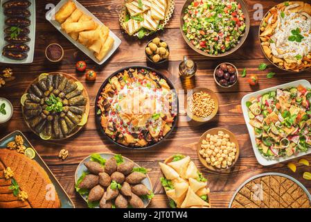 Cuisine arabe ; plats traditionnels du Moyen-Orient et meze variés. Feuilles de vigne, kibbeh, fatteh de poulet, rouleaux de printemps, sambusak, kibbeh et makdous. Banque D'Images