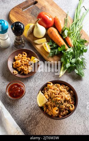 Plat et légumes. Plat en faïence. Légumes frais sur une planche à découper. Cadre vertical. Banque D'Images