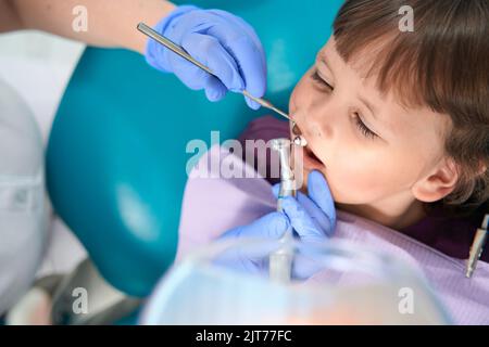 Dentiste pédiatrique effectuant une procédure de polissage des dents sur une femme enfant Banque D'Images