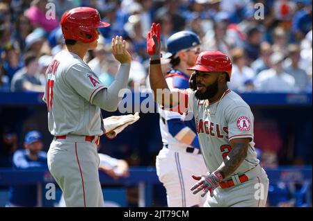 Shohei Ohtani (C) celebrates his third-inning home run with Los Angeles  Angels teammate Brett Phillips (L), holding a samurai warrior helmet,  during a baseball game against the Toronto Blue Jays at Angel