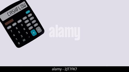 Calculatrice avec affichage du mot cash-flow et fond blanc. Lieu d'écriture Banque D'Images