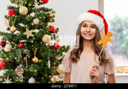 bonne adolescente à chapeau de père noël Banque D'Images