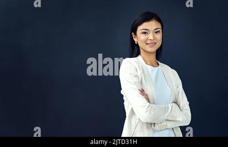 Regardez le monde, ici je viens. Studio portrait d'une jeune femme d'affaires. Banque D'Images