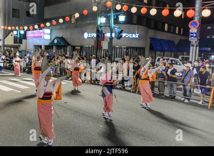 Tokushima, Japon - 12 août 2022 : des danseurs portant des kimonos roses se produisent au festival de rue japonais Banque D'Images