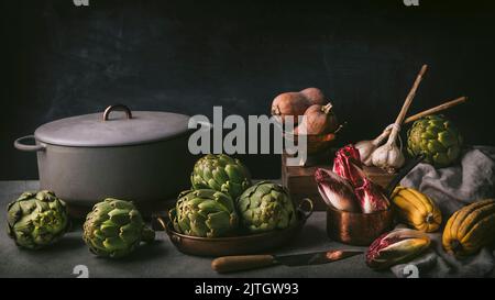 Moody front shot Still Life arrangement d'artichauts, endive rouge, ail et courge d'hiver. Inspiré par les peintures hollandaises Banque D'Images