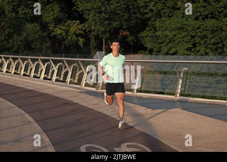 homme actif coureur courant dans les vêtements de sport en extérieur Banque D'Images