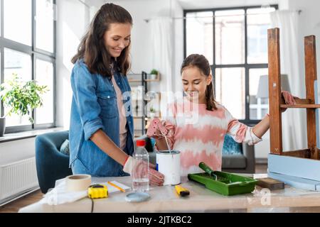 mère et fille remuant la peinture de couleur à la maison Banque D'Images