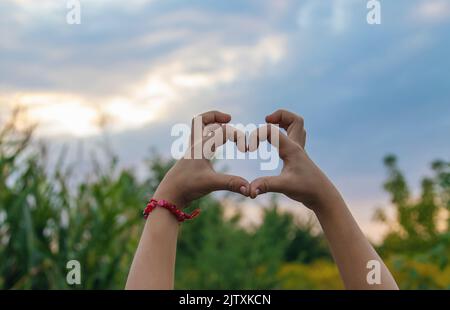 L'enfant fait un coeur avec ses mains. Mise au point sélective. Banque D'Images