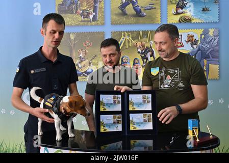 Irpin, Ukraine. 01st septembre 2022. Le président ukrainien Volodymyr Zelenskyy, au centre, tient le nouveau timbre-poste en l'honneur de Patron, le chien qui a briffé la bombe, parti, lors d'une cérémonie à l'école secondaire A. S. Makarenko, 1 septembre 2022 à Irpin, en Ukraine. En partant de la gauche : Mykhailo Iliev et son chien patron, le président ukrainien Volodymyr Zelenskyy et le directeur d'Ukrposhta Ihor Smilianski. Credit: Sarsenov Daniiar/Présidence ukrainienne/Alamy Live News Banque D'Images