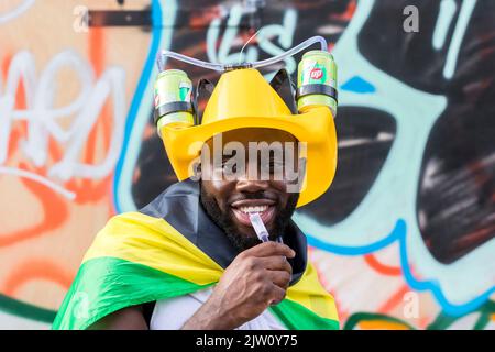 Notting Hill Carnival 2022 retourne à Londres après 3 ans en raison de la pandémie. Photo : un homme boit 7-up de son casque. Photo prise le 28th août Banque D'Images