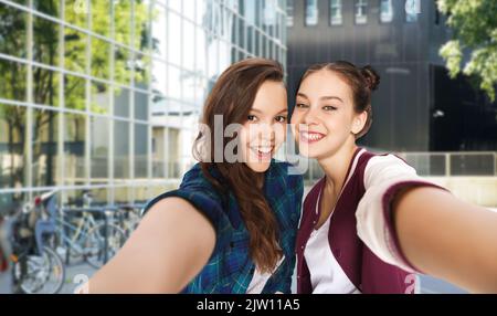 des adolescentes heureuses prenant le selfie dans la rue de la ville Banque D'Images