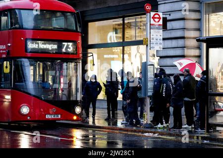 Photo du dossier datée du 01/03/22, de navetteurs faisant la queue pour un bus devant la station de métro Oxford Street à Londres. Les trajets en bus en Angleterre seront plafonnés à £2 de janvier à mars l'année prochaine, a annoncé le gouvernement. Cette décision, annoncée par le secrétaire aux Transports Grant Shapps, permettra de plafonner le prix d'un seul trajet en bus en Angleterre à £2 pendant trois mois, alors que les inquiétudes sur le coût de la vie ne cessent cet hiver. Date de publication : samedi 3 septembre 2022. Banque D'Images