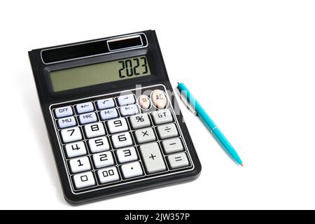 Calculatrice désactivée et stylo à bille sur fond blanc Banque D'Images