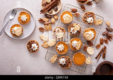 Mini-chaussons de citrouille et de noix de pécan cuits dans un moule à muffins Banque D'Images