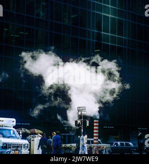 New York, 1980s ans, vapeur rétro-éclairée sortant de l'évent de la conduite de vapeur, système de chauffage urbain, centre-ville, Manhattan, New York City, NYC, NY, ETATS-UNIS, Banque D'Images