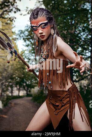 Portrait extérieur de la belle jeune shamaness (sorcière médecin) dans grove. Shaman (enchantress) se préparant au combat Banque D'Images