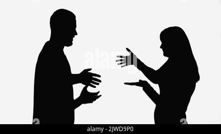 silhouettes noires de couple se querelant et gesturant isolées sur blanc Banque D'Images