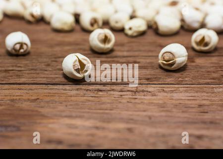 Dried lotus seeds on a wooden background. Stock Photo