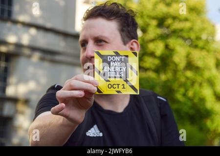 Londres, Angleterre, Royaume-Uni. 5th septembre 2022. Un manifestant détient un dépliant de campagne « ne payez pas de factures d'énergie ». Les manifestants se sont rassemblés devant Downing Street dans le cadre de la campagne Don't Pay contre les hausses massives des prix de l'énergie, alors que Liz Truss prend le poste de Premier ministre. Plus de 160 000 000 personnes se sont inscrites à la campagne et annuleront leurs paiements aux fournisseurs d'énergie le 1st octobre à moins que les prix ne batent. (Image de crédit : © Vuk Valcic/ZUMA Press Wire) Banque D'Images