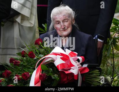 06 septembre 2022, Brandebourg, Fürstenberg/Havel: Wanda Poltawska, née en 1921 à lublin et survivante du camp de concentration de Ravensbrück, est assise en fauteuil roulant pendant l'enterrement des restes de femmes polonaises détenues dans le camp de concentration de Ravensbrück au cimetière. Les cendres des victimes du camp de concentration ont été récupérées en 2019 lors des fouilles de recherche menées par l'Institut polonais du souvenir national (IPN) au cimetière de Fürstenberg. Le tout premier jour de l'enquête, des urnes contenant les cendres et les restes de femmes polonaises assassinées ont été trouvées. Également préservé était un Banque D'Images