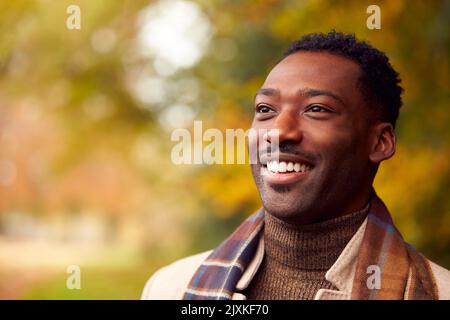 Tête et épaules Portrait de l'homme sur la marche à travers la campagne d'automne contre les feuilles d'or Banque D'Images