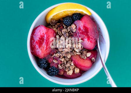 Une crumble de prune et de mûre maison. Le mélange de crumble est fait avec des flocons d'avoine grillés. Une alternative plus saine de garniture de granola à un crumble de farine Banque D'Images