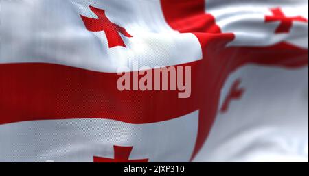 Vue rapprochée du drapeau national géorgien qui agite dans le vent. La Géorgie est un pays situé à l'intersection de l'Europe de l'est et de l'Asie occidentale. Tissu te Banque D'Images