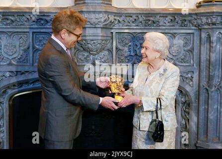 Photo du dossier datée du 4/4/2013 de la reine Elizabeth II recevant un BAFTA honoraire de Kenneth Branagh en reconnaissance d'un soutien à vie du film et de la télévision britanniques au château de Windsor. Date de publication : jeudi 8 septembre 2022. Le monarque n'a pas été farasé par des célébrités et a rencontré des centaines de stars du showbiz, des légendes pop et des grands hollywoodiens au cours des décennies, mais beaucoup ont admis avoir les nerfs à venir face à face avec le célèbre souverain régnant de longue date. Banque D'Images