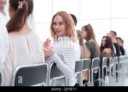Close up. Jeune femme assise dans une rangée avec ses associés. Banque D'Images