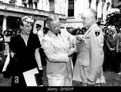 Le Président Truman décore Eisenhower - dans une brève cérémonie à la Maison Blanche, le Président Harry S. Truman remet la Médaille du service distingué (sa troisième) au général Dwight D. Eisenhower, Commandant suprême des forces alliées. Mme Eisenhower se trouve sur la gauche. 18 juin 1945. (Photo par ACME photo) Banque D'Images