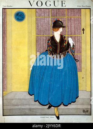 Couverture du magazine Vogue; fin octobre; publié par Cond Nast and Co., Londres; une dame porte une jupe bleue bouffante contre une porte jaune. Banque D'Images