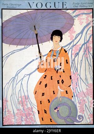 Couverture du magazine Vogue, numéro du début avril, publié par Cond Nast and Co., Londres; une dame tient un parasol sous un arbre et porte une tenue orange avec un chapeau à large bord. Banque D'Images