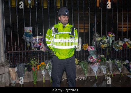 LONDRES, ANGLETERRE - SEPTEMBRE 08 : les policiers se tiennent parmi les hommages floraux laissés à l'extérieur de Buckingham Palace dans le centre de Londres, après l'annonce de la mort de la reine Elizabeth II.Credit: Horst A. Friedrichs Alay Live News Banque D'Images