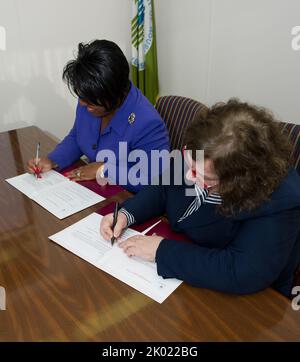 Signature d'un accord de service, avec la directrice du capital humain en chef, Janie Payne, la directrice de la politique et de la gestion sur le terrain, Patricia Hoban-Moore, et d'autres fonctionnaires présents. Banque D'Images