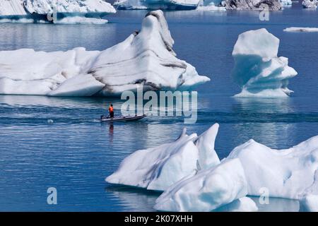 Canot en caoutchouc devant les icebergs dans le lagon du glacier de Joekulsarlon, parc national de Vatnajoekull, Hornarfjoerdur, Islande Banque D'Images