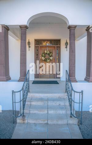 Centre-ville de Tucson, Arizona - Grande porte en bois sculpté avec couronne et rambardes sur les sidelights et le tableau arrière. Entrée principale avec mains courantes pour les escaliers et le bro Banque D'Images