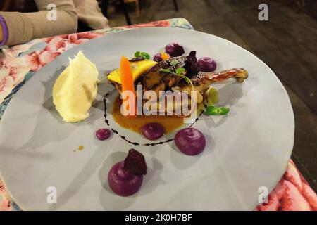 Gros plan de foie gras poêlé servi avec du pain grillé au gingembre croustillant et de la salade balsamique verte Banque D'Images