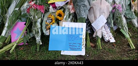 Des bouquets , des hommages écrits, des jouets en peluche, des bougies et des cartes ont été posés en l'honneur de la Reine Elizabeth à Green Park et des milliers de personnes ont continué à affluer à la résidence royale Buckingham Palace dans le centre de Londres. Banque D'Images