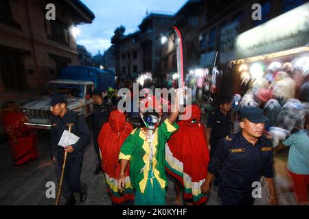 Bhaktapur, Bagmati, Népal. 12th septembre 2022. Des personnes décorées de couleurs différentes dans leurs visages font le tour de la ville de Baktapur pour marquer le festival de Mupatra à Bhaktapur. Au cours de la procession, il est d'usage pour trois personnes, dont le chef Mupatra et deux autres assistants nommés Dhischa, de s'habiller comme des monstres, de tenir des épées dans des couleurs différentes sur leurs visages et des faire marcher dans la ville. Tout en encerclant la ville, le démon Mupatra tourne trois fois et frappe Yamadyo, qui se trouve sur la place de péage des dévotés, avec une épée. (Image de crédit : © Amit Machamasi/ZUMA Press Wire) Banque D'Images