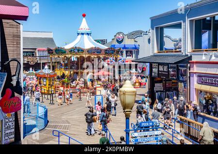 Une vue sur les gens à l'embarcadère 39 de San Francisco avec un carrousel au centre de l'expérience touristique. Banque D'Images