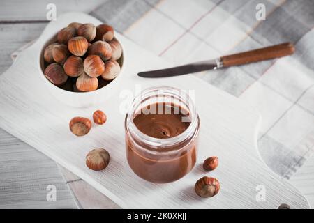 Tartiner au chocolat au lait noisette maison sur fond de bois blanc Banque D'Images